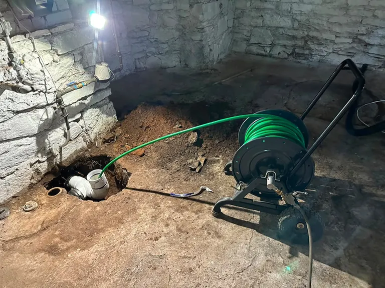 Hydro jetting a main sewer line through a new PVC cleanout in an excavated basement floor — hydro jetting in Corbin City, NJ
