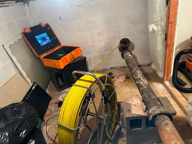 Sewer camera fed into a basement cast-iron main sewer line during a video inspection — sewer camera inspection in Barnegat, NJ