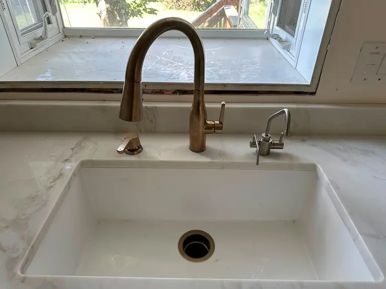 Brushed-gold pull-down kitchen faucet installed — Lumin Drain NJ