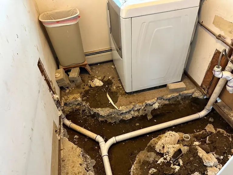 New PVC sewer and drain branch lines installed under a laundry room slab — sewer line repair in Hardwick, NJ