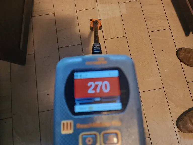 Moisture meter reading confirming a hidden water leak in the flooring near a sink cabinet — Leak Detection & Repair in Eatontown