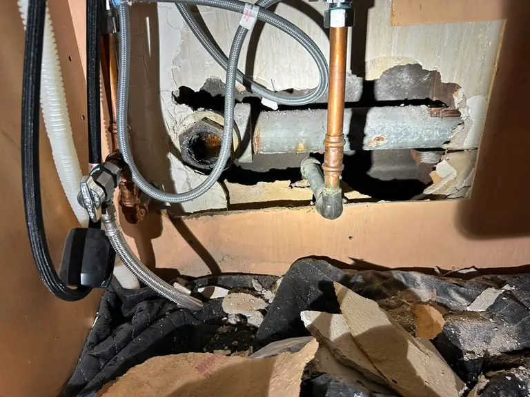 Old galvanized pipe beside newer copper supply lines — Lumin Drain NJ