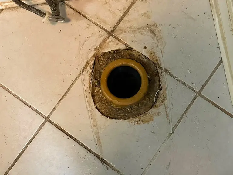 Old toilet removed showing the worn wax ring and flange before replacement — toilet repair in New Jersey