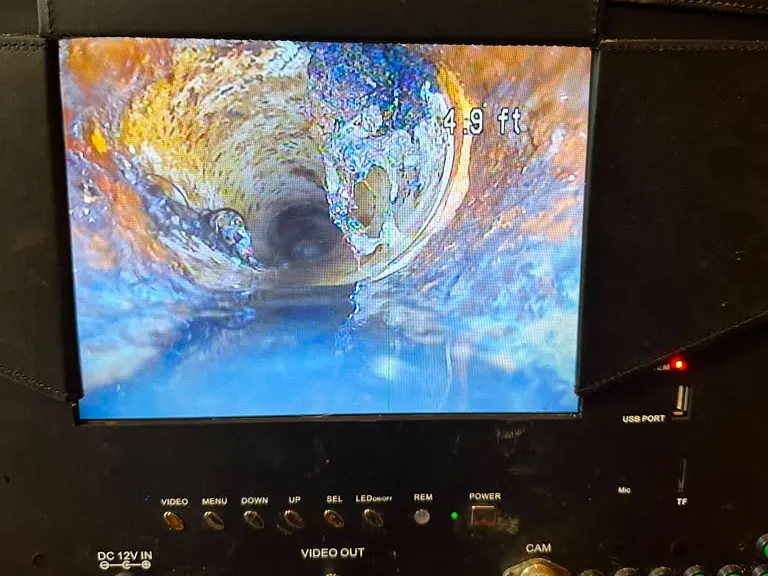 Sewer inspection monitor showing live camera footage inside a drain pipe with on-screen distance readout — Sewer Camera Inspection in Eatontown