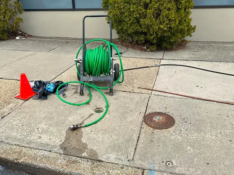 Hydro jetting a sewer lateral from a sidewalk cleanout with high-pressure hose reel — hydro jetting in Manville, NJ