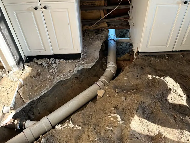New under-slab sewer line installed beneath kitchen cabinets after concrete removal — sewer line repair in Walpack, NJ