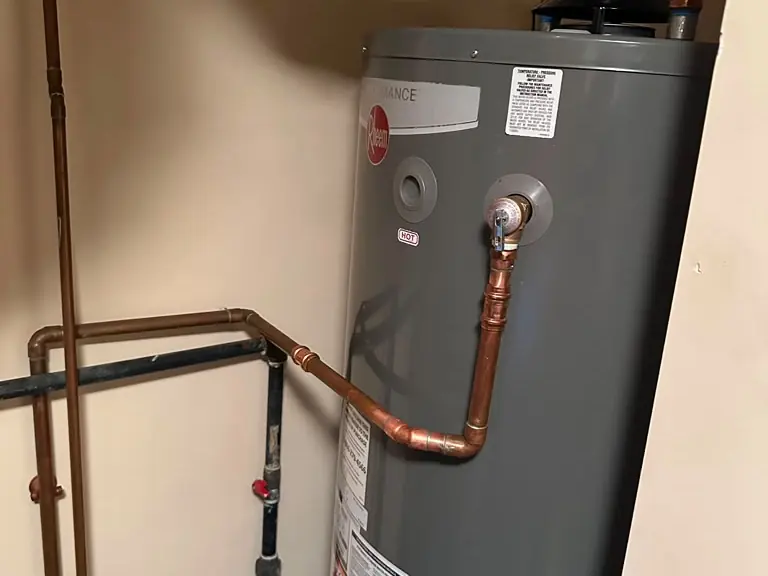 New water heater with copper temperature and pressure relief valve piping and flue vent connection — water heater installation and repair in Plainfield, NJ